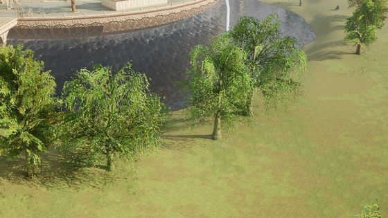 A stone bridge across a lake beneath a hilltop town